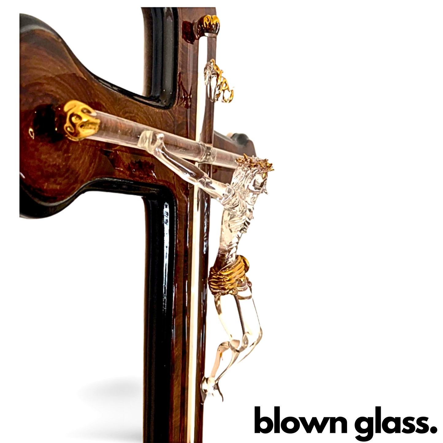 Handmade blown glass sculpture of Jesus on the cross, measuring 7" by 7". Perfect as a unique wall decoration.