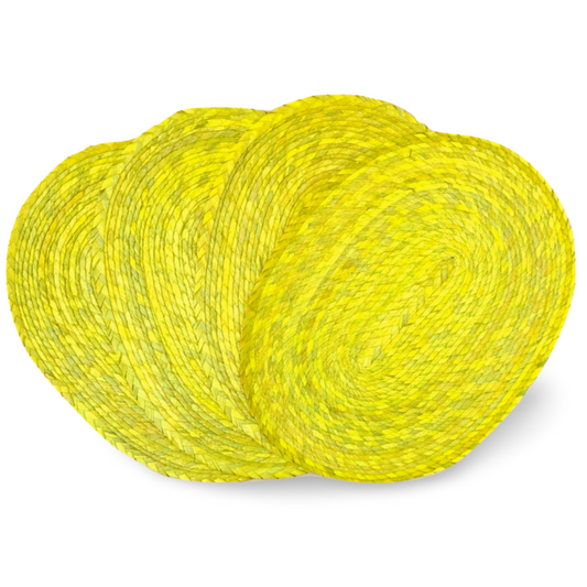 Set of 4 vibrant yellow placemats, handwoven in Mexico from eco-friendly palm leaves, perfect for indoor or outdoor dining.