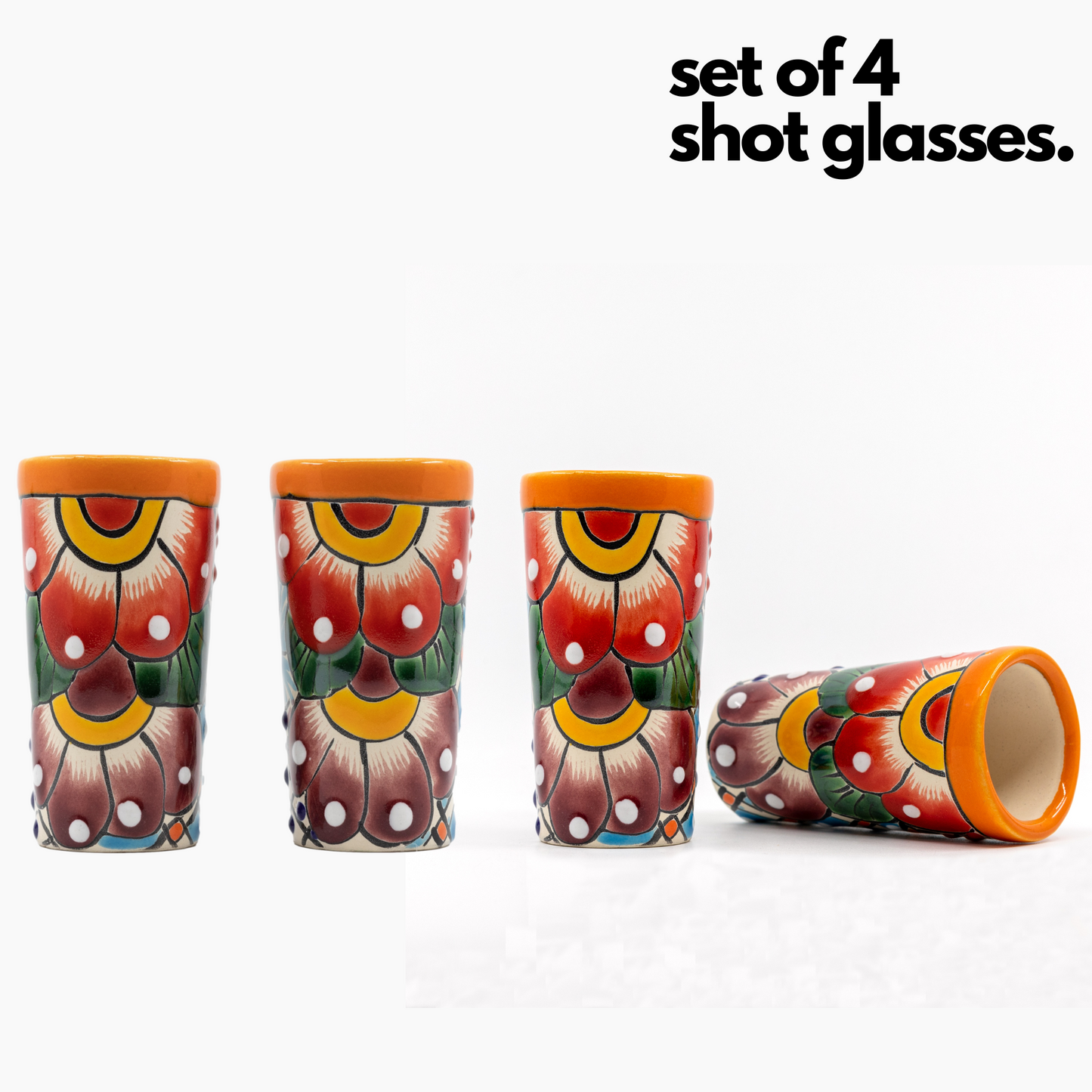 Set of four colorful hand-painted Mexican shot glasses, perfect for tequila or mezcal.