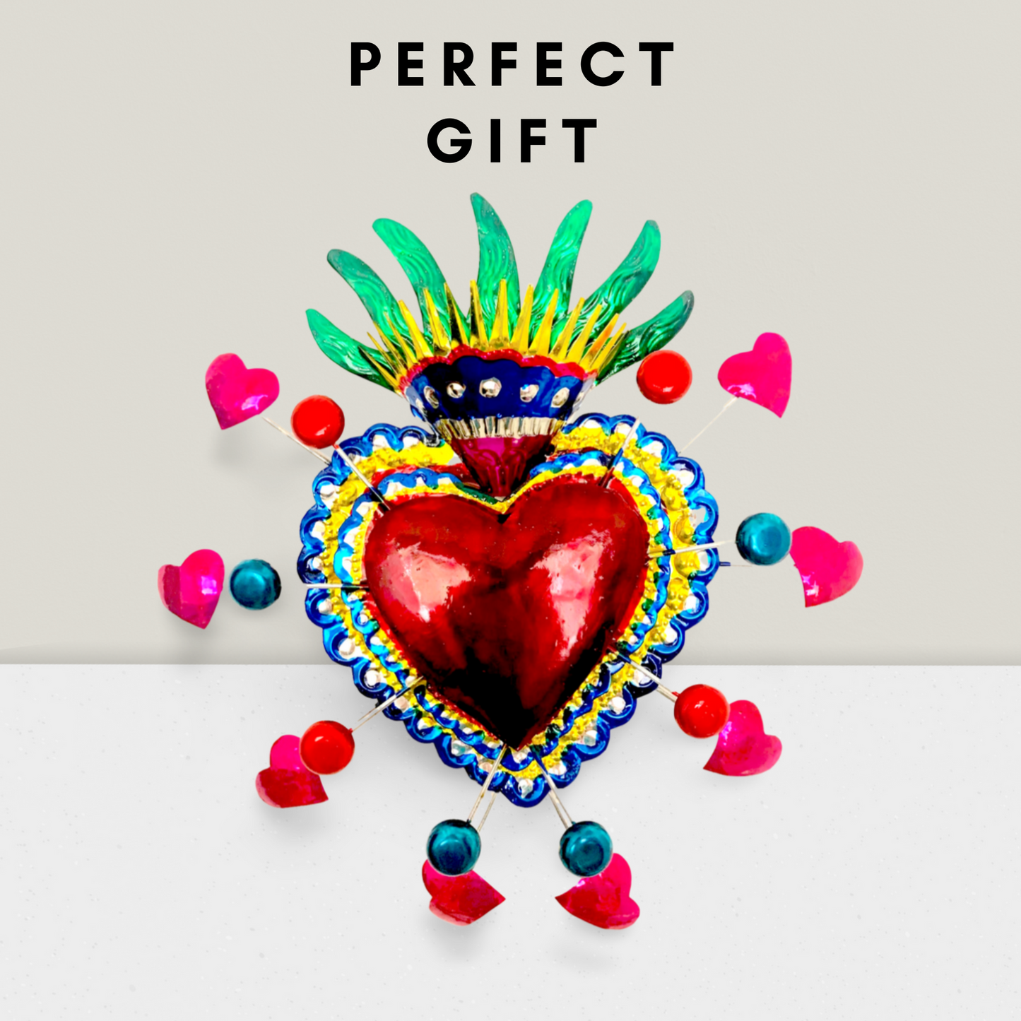 Vibrant, handcrafted Embossed Tin Heart Milagro wall decor, a unique piece of Mexican folk art, adding color and charm to any space.