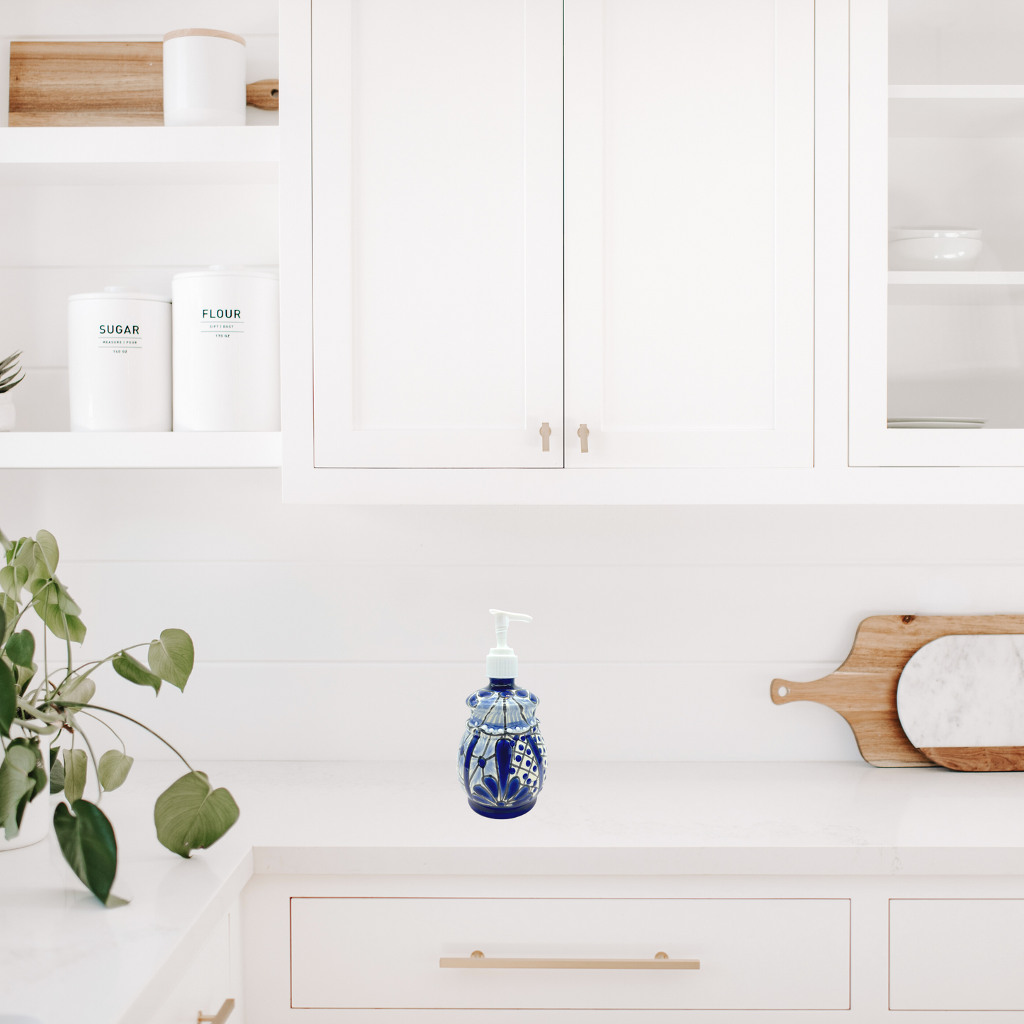 Hand-painted Talavera Ceramic Soap Dispenser in blue and white, a unique addition to kitchen or bathroom decor placed on a kitchen sink