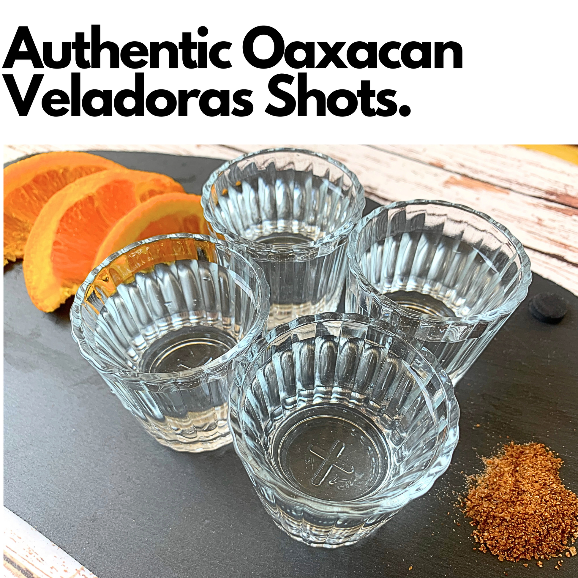 A set of 4 Mexican Vaso Veladoras shot glasses, lead-free, with a unique cross symbol at the base, perfect for serving Mezcal, Tequila, and Sangrita.
