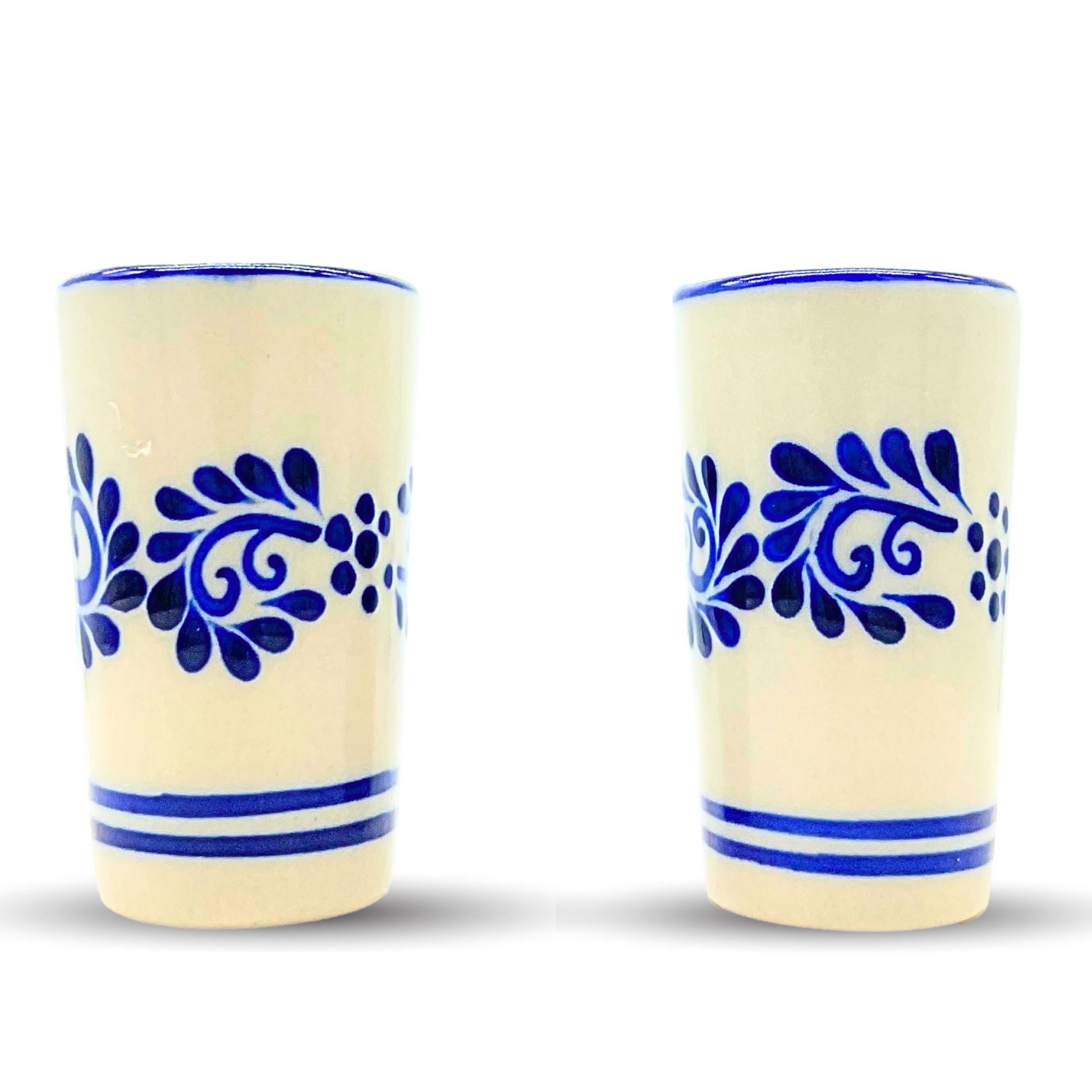 A set of two vibrant, hand-painted Mexican ceramic shot glasses, perfect for serving tequila or mezcal.