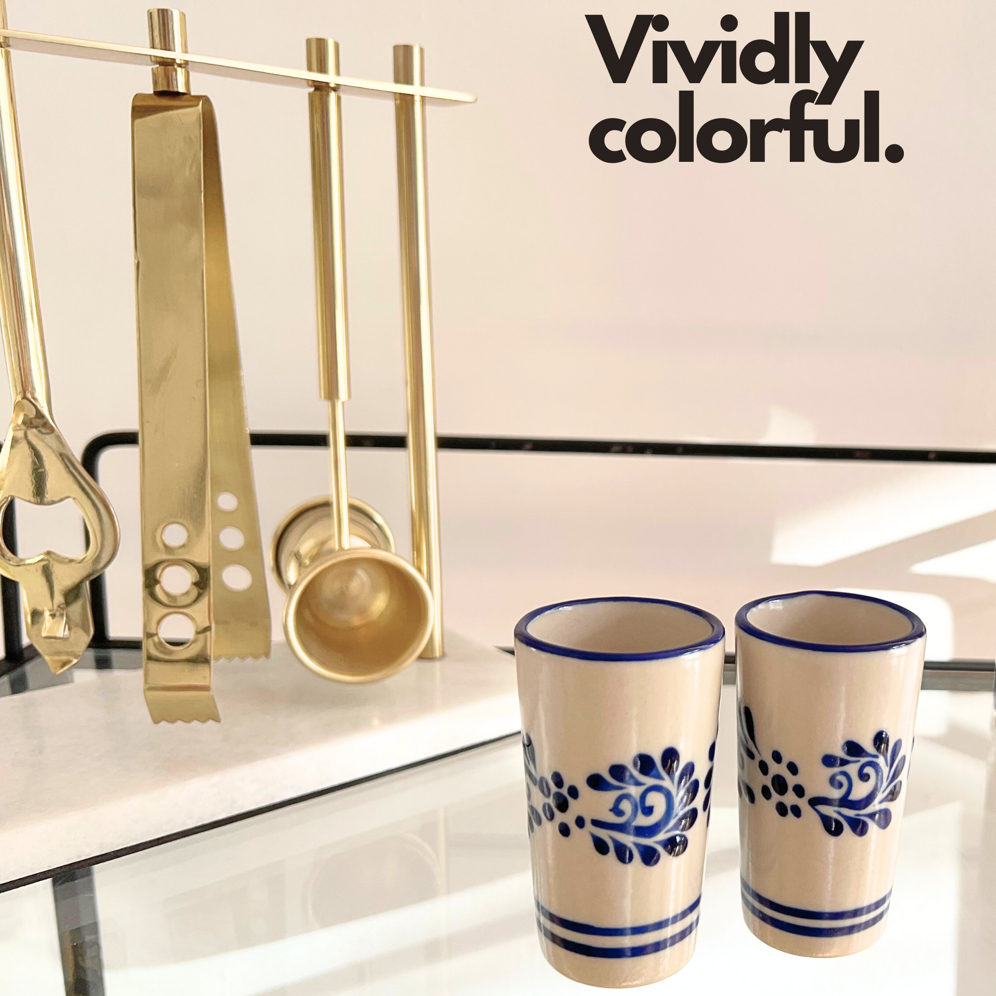 A set of two vibrant, hand-painted Mexican ceramic shot glasses, perfect for serving tequila or mezcal.