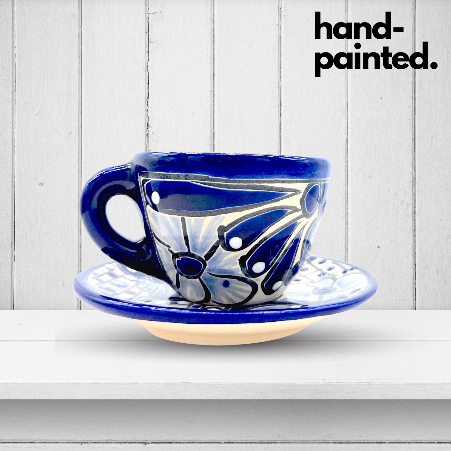 A blue and white, floral, hand-painted Talavera ceramic espresso cup and saucer set, bringing vibrant Mexican culture to your morning coffee ritual.