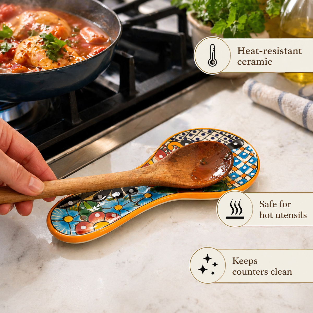 Colorful Talavera-style Mexican ceramic spoon rest, hand-painted in Mexico — in use on a marble kitchen counter, holding a wooden spoon beside a simmering