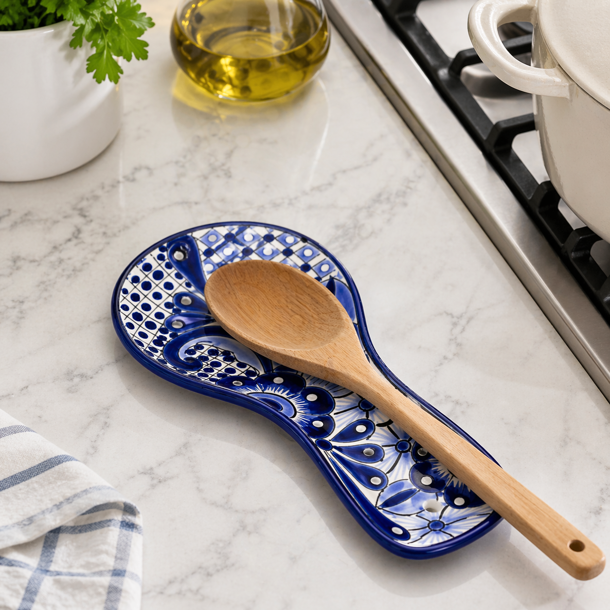 Blue and white Talavera-style ceramic spoon rest, hand-painted in Mexico — angled view