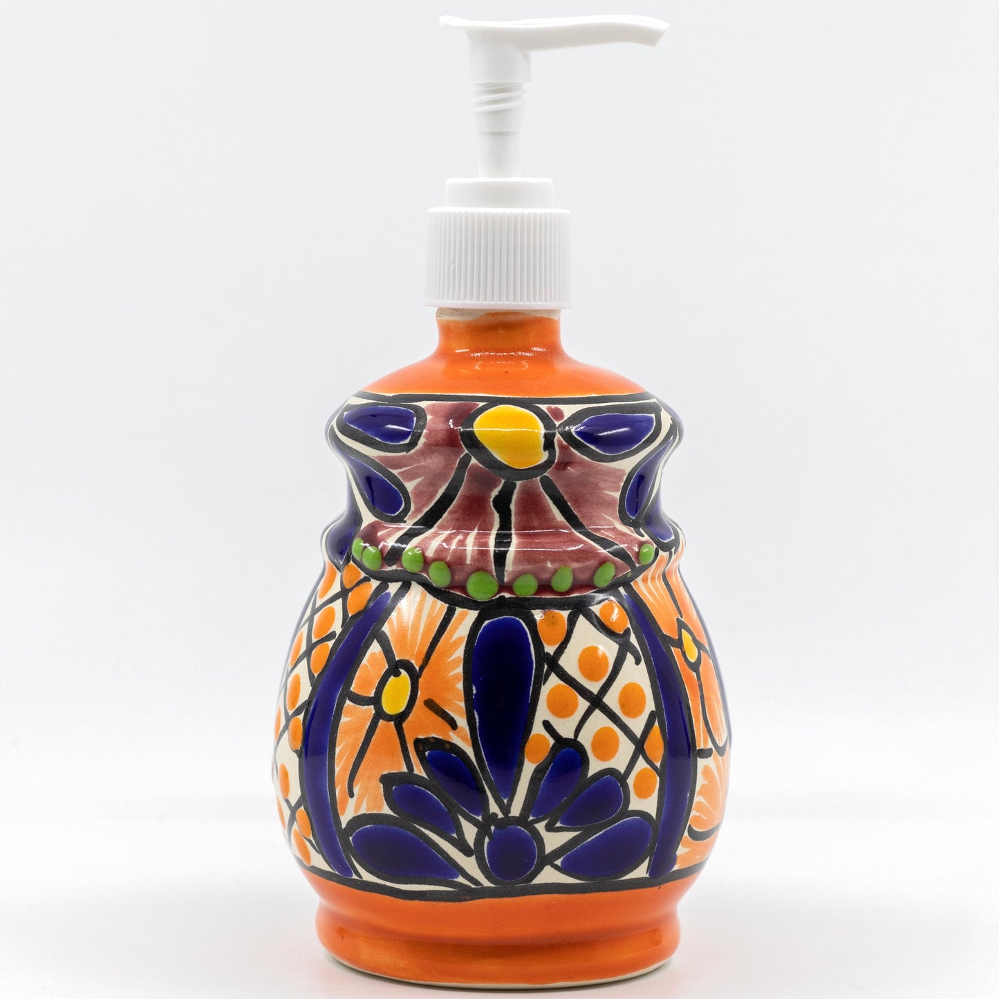 front of A multicolored, bell design, hand-painted Talavera ceramic soap dispenser sourced from skilled Mexican artisans.
