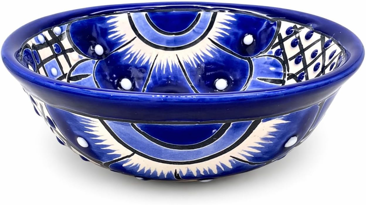 Blue and white Talavera-style ceramic salsa bowl, hand-painted in Mexico — three-quarter view showing the painted interior