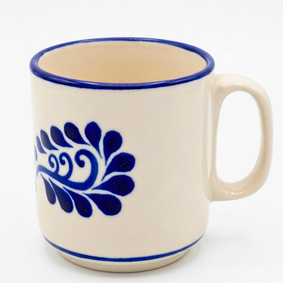 Classic white Talavera-style Mexican coffee mug with blue flourishes and a handle