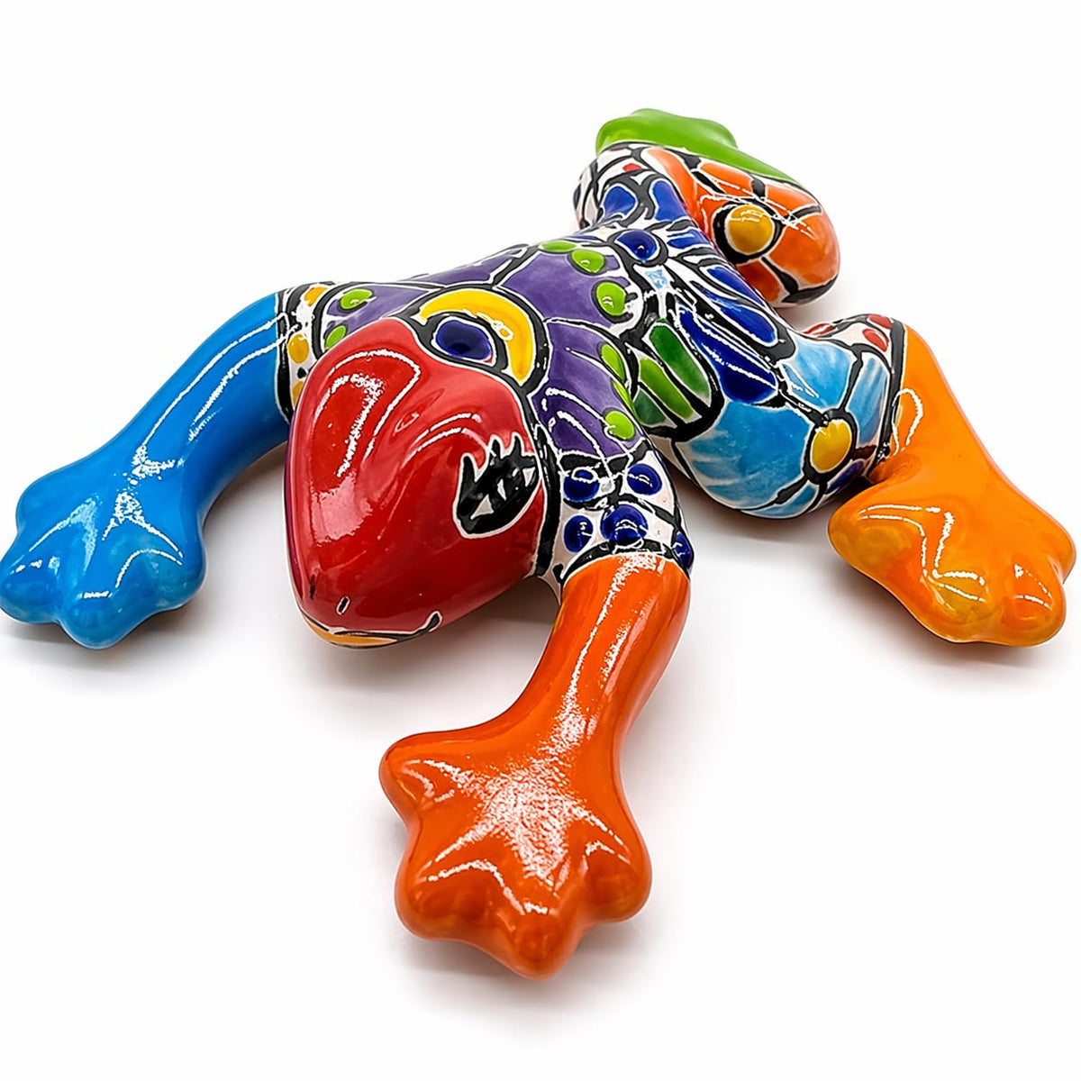 Colorful Talavera-style ceramic frog on a white background