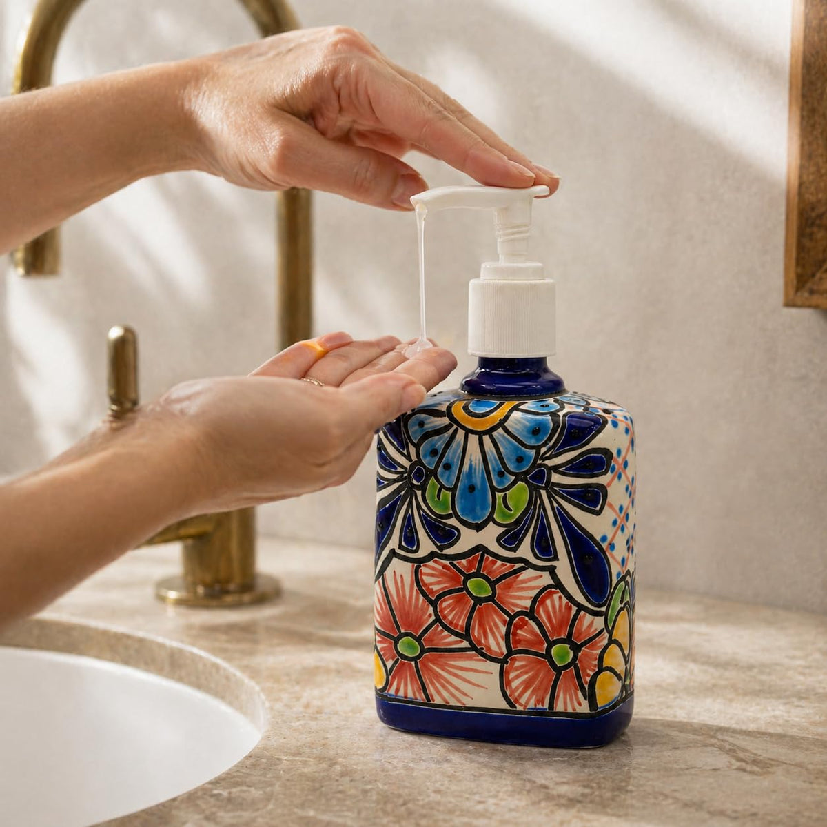 Hands using the rectangular soap dispenser at a sink