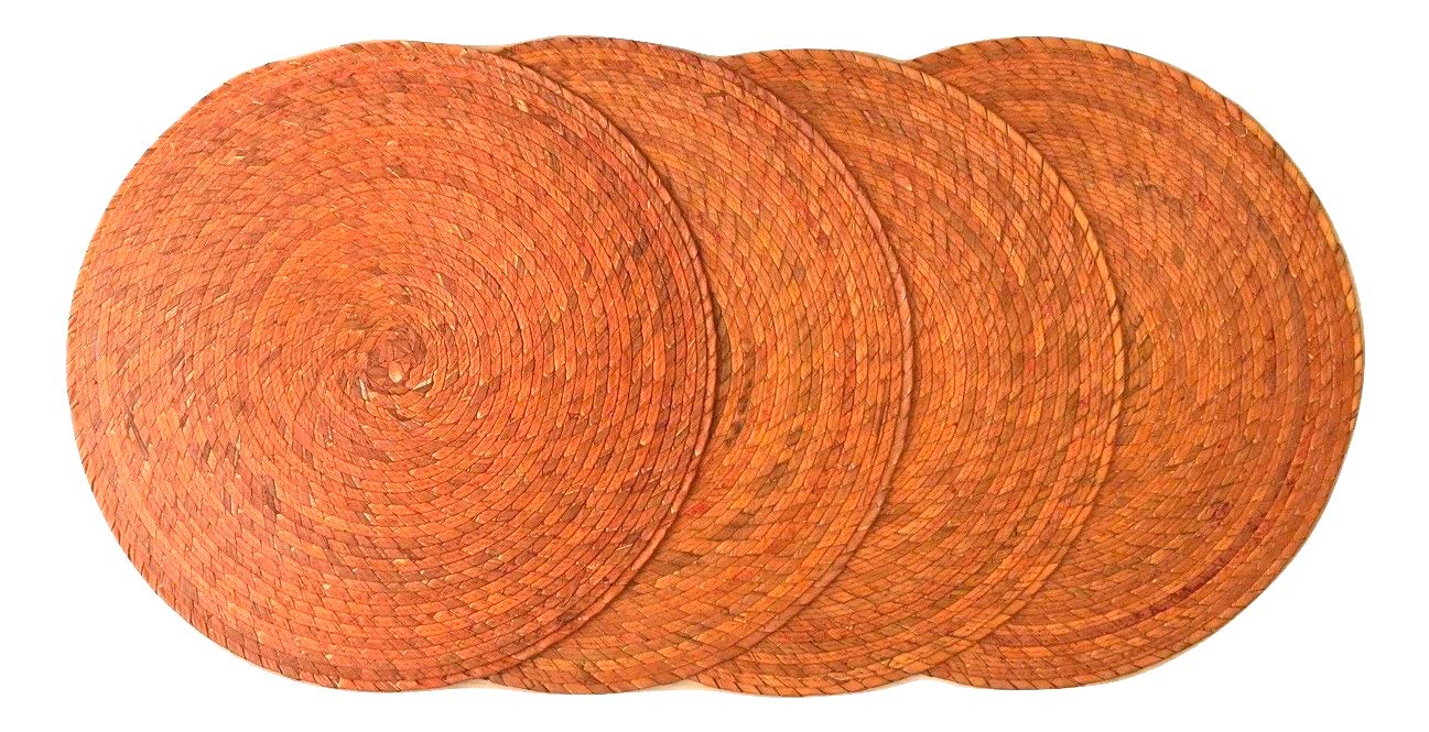 Orange round woven palm placemats set of 4, handmade Mexican table decor — top view